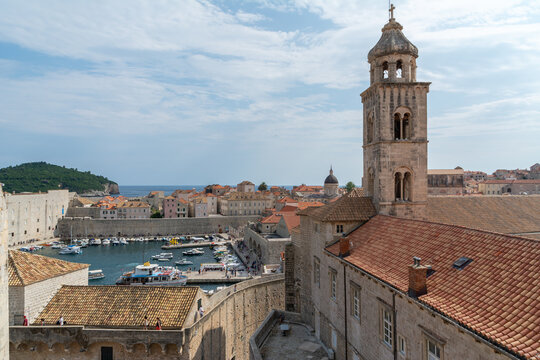 Panoramic view of Dubrovnik old town rooftops and bell tower with harbor and Adriatic Sea in Croatia