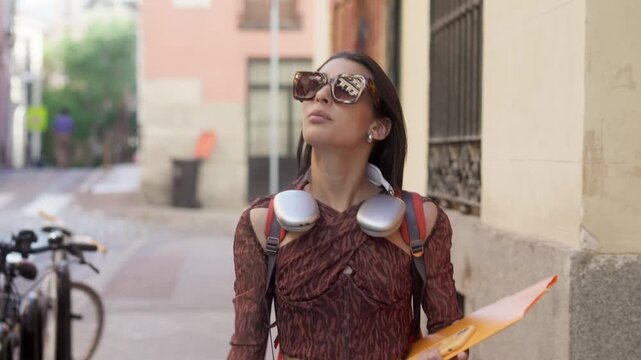Happy young woman dancing in the street on her way to university