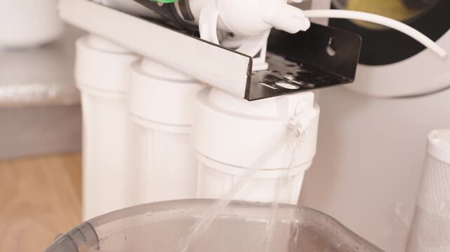 Water Flowing from the Reverse Osmosis System During a Test Flush of the New Filters, Performing a Leak Test to Ensure Proper Installation and Functionality