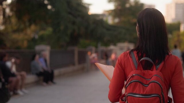 Young student exploring the city at sunset