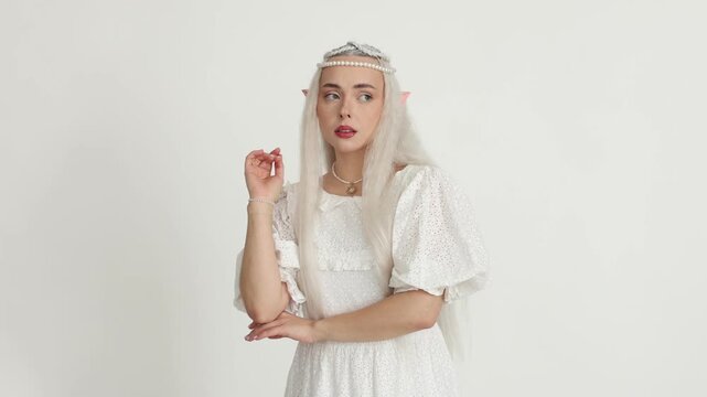 Beautiful girl dressed as elf on white background