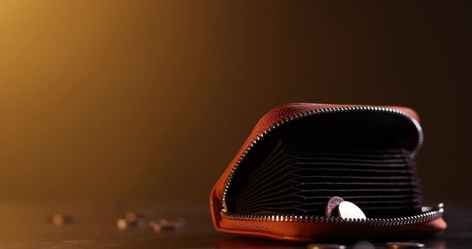 Many coins falling onto wallet on wooden table, closeup. Space for text