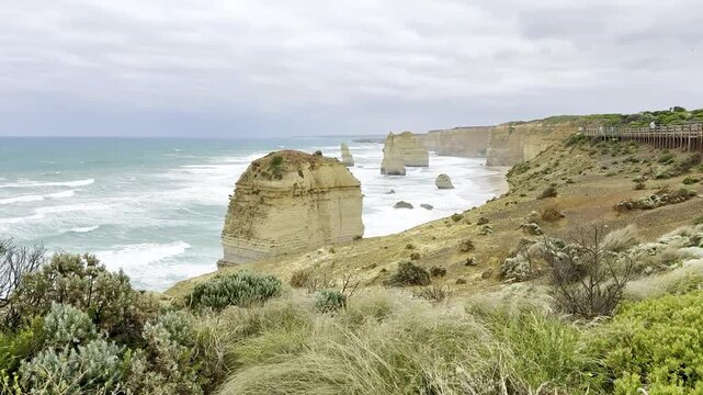 Powerful waves crashing against the limestone cliffs, stacks of the Twelve Apostles in Port Campbell National Park on the Great Ocean Road, Victoria, Australia
