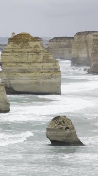 Powerful waves crashing against the limestone cliffs, stacks of the Twelve Apostles in Port Campbell National Park on the Great Ocean Road, Victoria, Australia