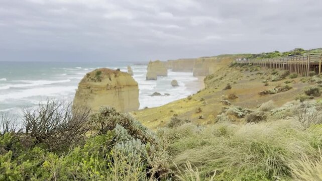 Powerful waves crashing against the limestone cliffs, stacks of the Twelve Apostles in Port Campbell National Park on the Great Ocean Road, Victoria, Australia