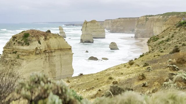 Powerful ocean waves crashing against the dramatic cliffs at the Loch Ard Gorge viewpoint near the Twelve Apostles on the Great Ocean Road, Victoria, Australia