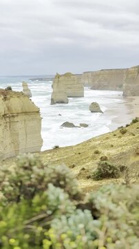 Powerful ocean waves crashing against the dramatic cliffs at the Loch Ard Gorge viewpoint near the Twelve Apostles on the Great Ocean Road, Victoria, Australia