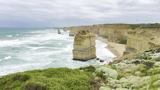 Powerful ocean waves crashing against the dramatic cliffs at the Loch Ard Gorge viewpoint near the Twelve Apostles on the Great Ocean Road, Victoria, Australia