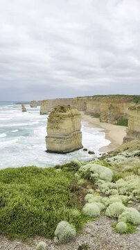 Powerful ocean waves crashing against the dramatic cliffs at the Loch Ard Gorge viewpoint near the Twelve Apostles on the Great Ocean Road, Victoria, Australia