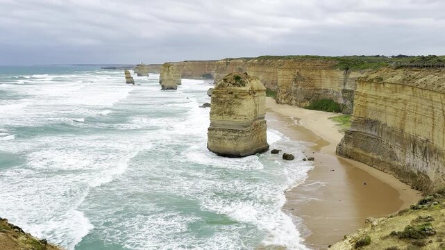 Powerful waves crashing against the limestone cliffs, stacks of the Twelve Apostles in Port Campbell National Park on the Great Ocean Road, Victoria, Australia