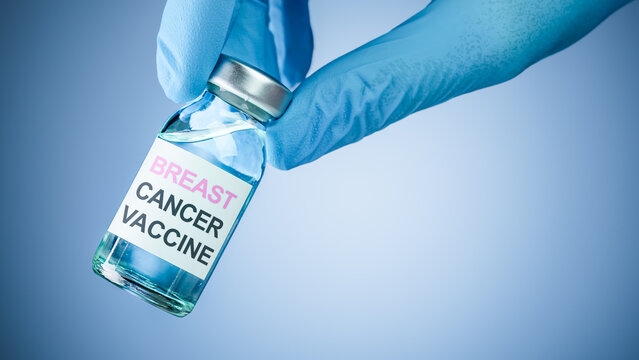 Nurses hand in blue medical gloves holding a vaccine bottle with Breast Cancer Vaccine text. Health care concept of comprehensive vaccines for prevention or treatment of breast cancer.
