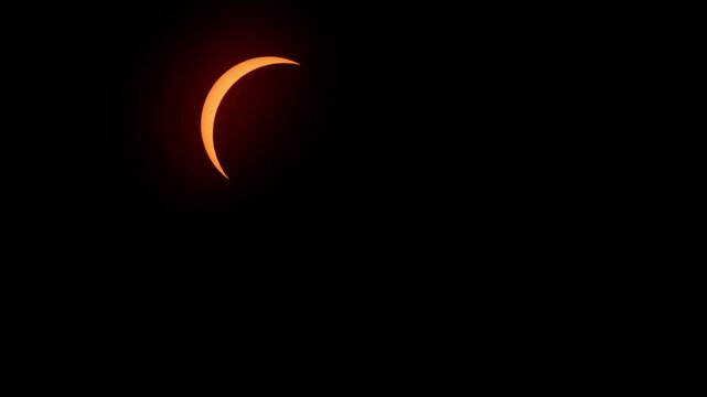 Cinematic footage of the partial solar eclipse creating a glowing crescent sun above Halifax, Nova Scotia, Canada on April 8, 2024. Beautiful and rare astronomical phenomenon 4K.