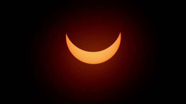 Close-up and wide shot of the partial solar eclipse forming a stunning glowing crescent. Observed in Halifax, Nova Scotia, Canada on April 8, 2024, beautiful celestial event 4K.