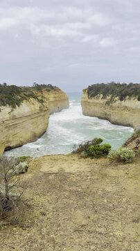 Powerful waves crashing against the limestone cliffs, stacks of the Twelve Apostles in Port Campbell National Park on the Great Ocean Road, Victoria, Australia
