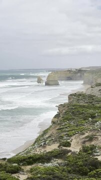Powerful waves crashing against the limestone cliffs, stacks of the Twelve Apostles in Port Campbell National Park on the Great Ocean Road, Victoria, Australia