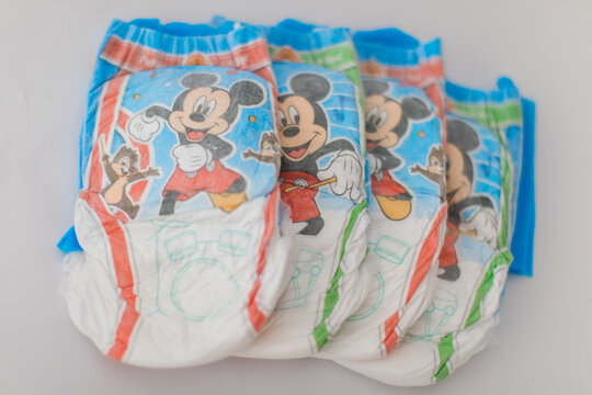 four 3-4t pullups diapers on white background with mickey mouse 