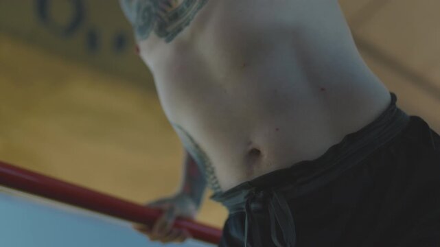 Tattooed muscular man doing triceps dips