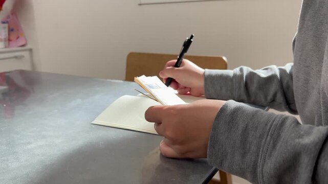 家計簿をつける主婦の手