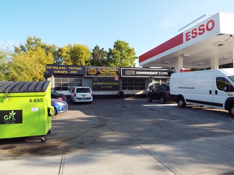 Vanier, Ontario, Canada &ndash; July 25, 2025: An "Esso gas station features Crown Motors automotive services and a convenience store" at 550 Donald Street.
