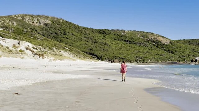 Happy girl walks along the stunning paradise Squeaky Beach with white sand and turquoise water in Wilsons Promontory National Park, Squeaky Beach Road, Yanakie, Victoria, Australia
