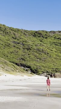 Happy girl walks along the stunning paradise Squeaky Beach with white sand and turquoise water in Wilsons Promontory National Park, Squeaky Beach Road, Yanakie, Victoria, Australia