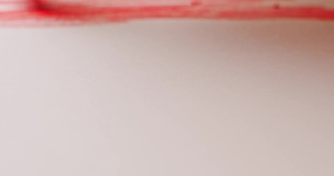 Close up of coloring a rainbow with crayons on plain white paper. Celebrating pride month with bright crayon colors creating a hand drawn rainbow flag.