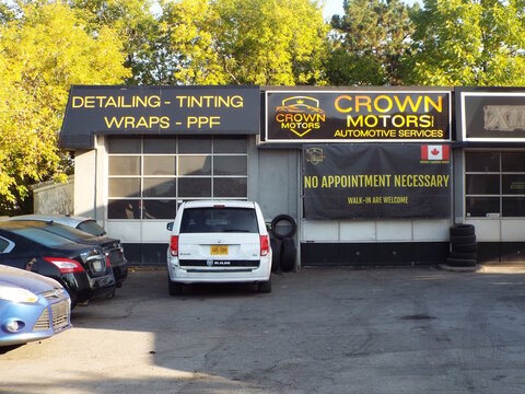 Vanier, Ontario, Canada &ndash; July 25, 2025: "Crown Motors Automotive Services" offers detailing, tinting, and wraps at 550 Donald Street, featuring a "No Appointment Necessary" banner.
