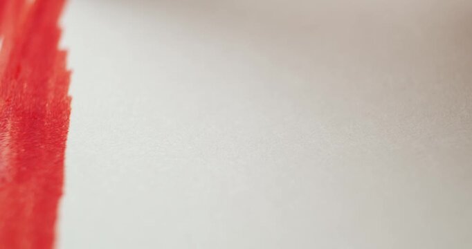 Close up of coloring a rainbow with markers on plain white paper. Celebrating pride month with bright ink colors creating a hand drawn rainbow flag.