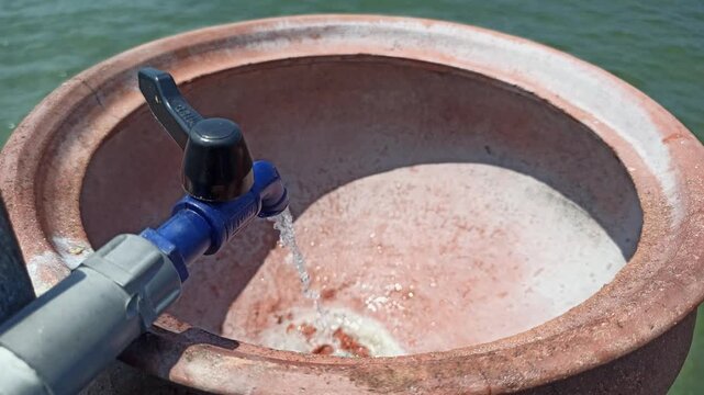 A simple handwashing station using a clay jar, offering a traditional and natural way to maintain hygiene with an earthy and rustic aesthetic.