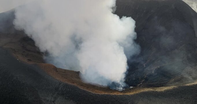Close up Mount Yasur volcano crater, active stratovolcano on Tanna Island, Vanuatu erupting ash and smoke from its active crater, raw geological power and natural spectacle. Aerial view drone panorama