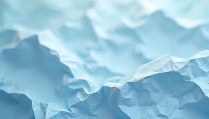 Obraz premium Light blue crumpled paper shows abstract landscape texture. Soft folds create mountain like shapes. Empty surface ideal for backgrounds or design elements.