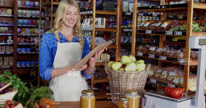 Store clerk checking clipboard, lifting chalkboard sign reading Organic and smiling in market