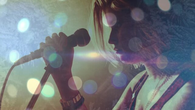 Vertical video: Female singer raising mic and singing for music amid bokeh lens-flare overlays