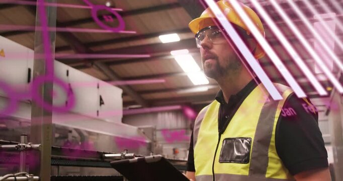 Worker holding tablet, reading data and doing factory safety check while magenta overlays moving