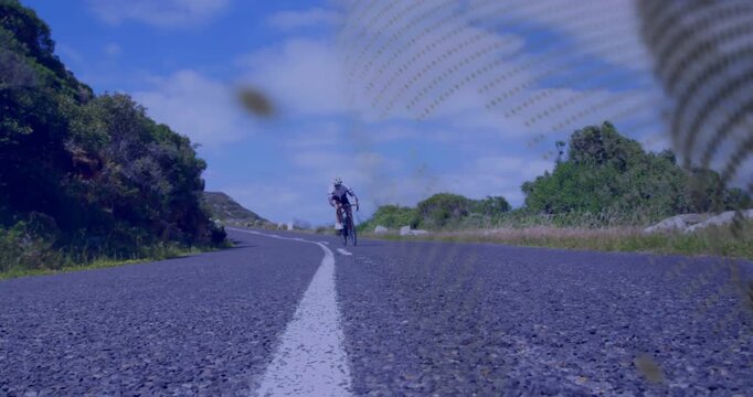 woman cyclist pedaling toward centerline camera for sports, leaning, front wheel crossing mesh