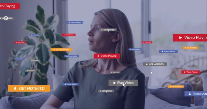 Woman sitting on sofa by window, badges appearing, raising arm, hiding face, showing tech overload