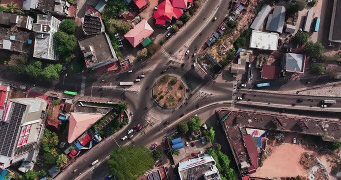 Aerial view of car traffic at the roundabout, lane and buildings in Thiruvananthapuram, Kerala, India. Beautiful cinematic shot of an Indian City.
