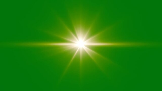 Bright lens flare effect on green screen background. golden light lens flare green screen alpha channel. Cinematic lens flare overlay. Shining star and light rays motion graphics on Green screen