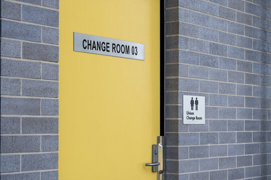 Unisex change room entrance with signage on a door in a public sports facility in Australia. Community infrastructure with inclusive design, accessibility, and recreational amenities.