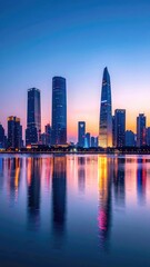 Obraz premium A stunning twilight view of a modern cityscape reflected in calm waters, showcasing towering skyscrapers bathed in vibrant hues.