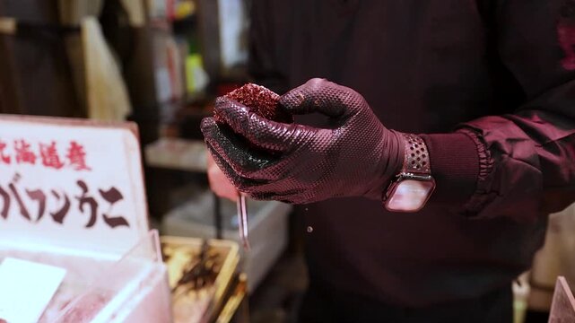 Chef Preparing Fresh Sea Urchin with Tweezers at Osaka Seafood Market
