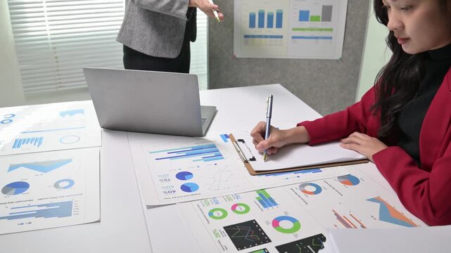 Business analyst taking notes during a meeting