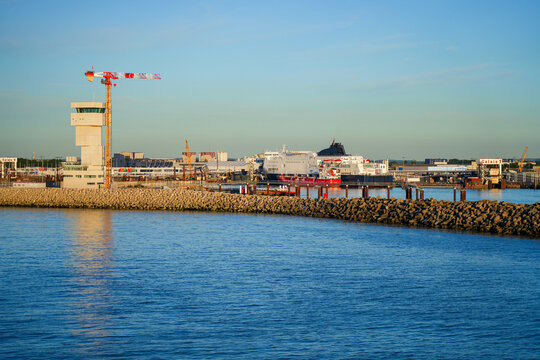 The port control tower and DFDS ferry at the Port of Calais during golden hour, France
