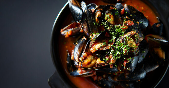 Tomato mussel soup in a pot
