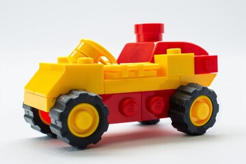 Obraz premium Toy block car lego yellow red simple design white background kids building playful construction model
