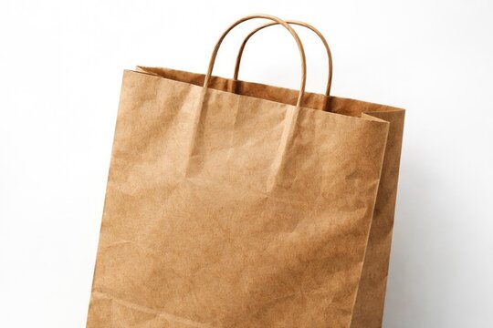 Close up of textured brown paper bag on white background showcasing eco friendly material