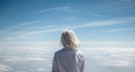 Fototapeta premium Tranquil white haired woman in a shirt reflecting on the vast sky above