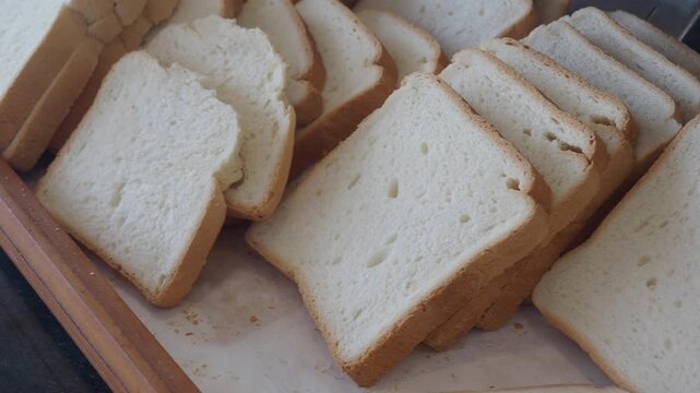 Freshly sliced bread on a wooden table at the bakery
