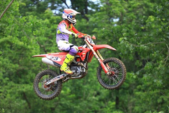 Dirt bike rider doing a big jump. Supercross, motocross, high speed. Sport concept