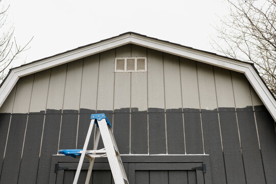 Updating an old barn with a dark grey paint color. 